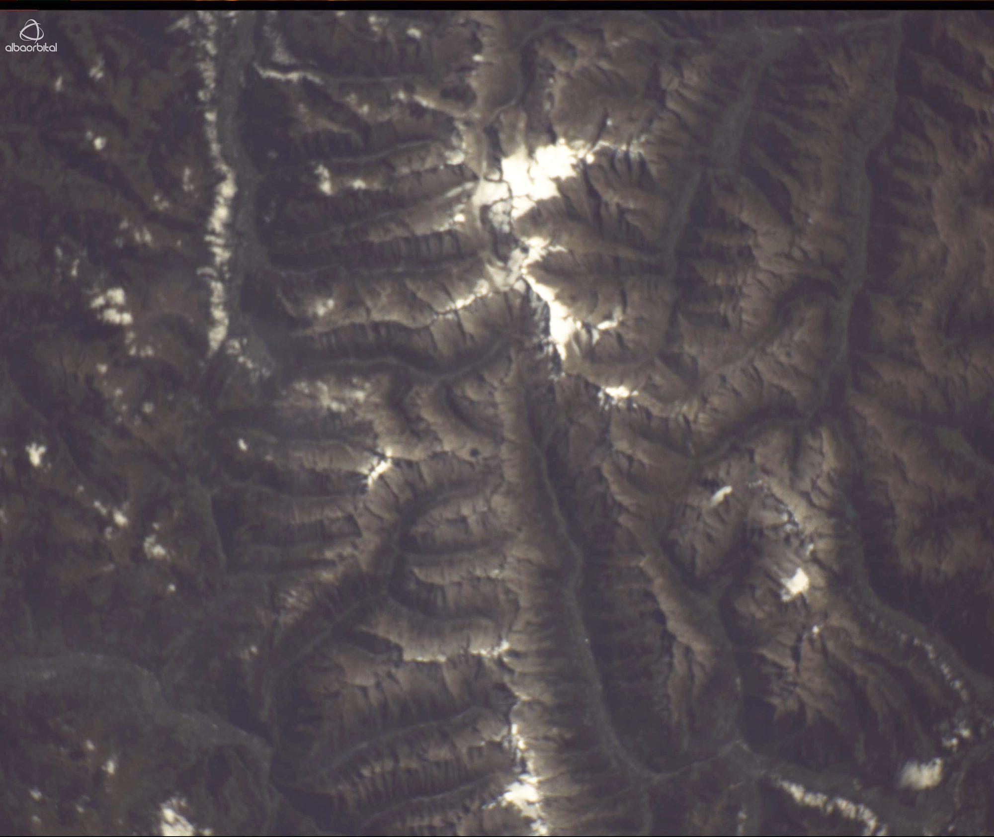 Snow on a mountain range, photographed from orbit